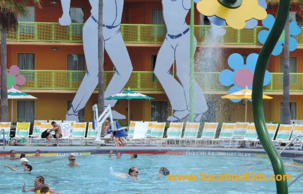 Psycodelic flower fountains mist the pool guests at the Hippy Dippy pool at Disney's Pop Century Resort