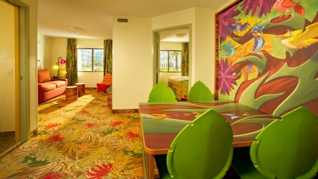 Art Of Animation Lion King family suites comfortably sleep 6 with a living room, separate master bedroom, Two full bathrooms and a dining room with a table that converts to a double bed.