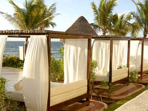 Relax upon ocean front beach beds at Hotel Marina El Cid