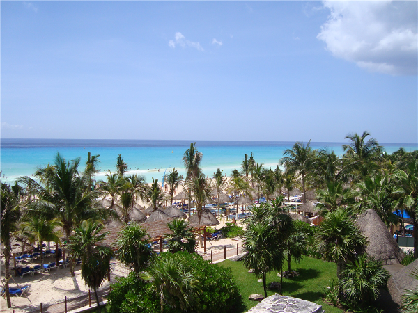 Enjoy the beach and bright blue waters of the Sandos Playacar Beach Resort & Spa