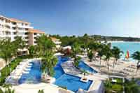 View of main pool area with 30 person jacuzzi and ocean view at Dreams Puerto Aventuras Resort