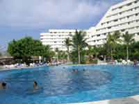 Oasis Palm Beach View of main building from poolside