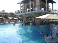 Relax with a refreshing drink at the Swim up bar in the pool by the Italian Village at Beaches Turks & Caicos.