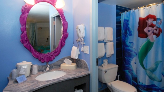 Art of Animation bathrooms offer a sink dressing area that is separated by a door to the bathroom that has the toilet and shower. All the decor will make you feel like you are deep in the ocean with Arial