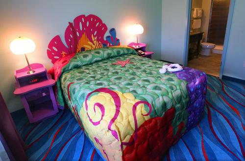 The colorful master bedrooms at Art Of Animation Finding Nemo have a door for privacy, Queen size bed, Flat Screen TV and full bath with a shower