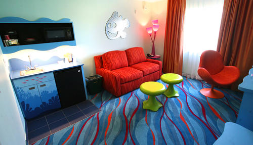 The Living Room area in Art Of Animation Finding Nemo Suites offers families a double sleeper sofa and mini kitchenette with small fridge, microwave and sink