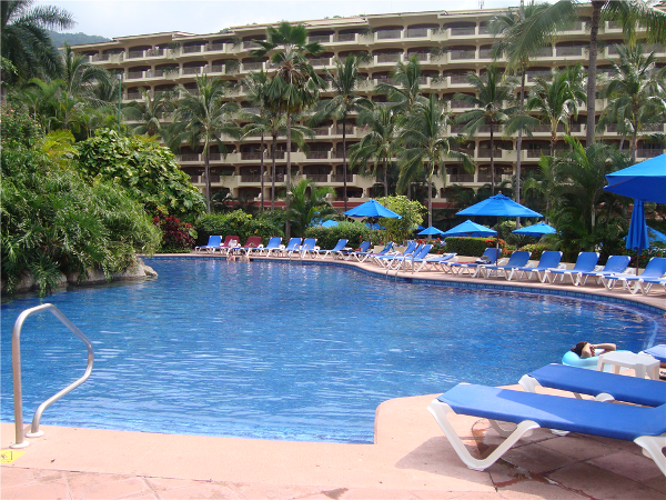 Relax by the pool with a refreshing drink at Barcelo Puerto Vallarta