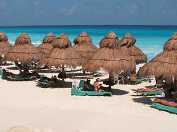 Omni Cancun Hotel and Villas beach view of shady palapas