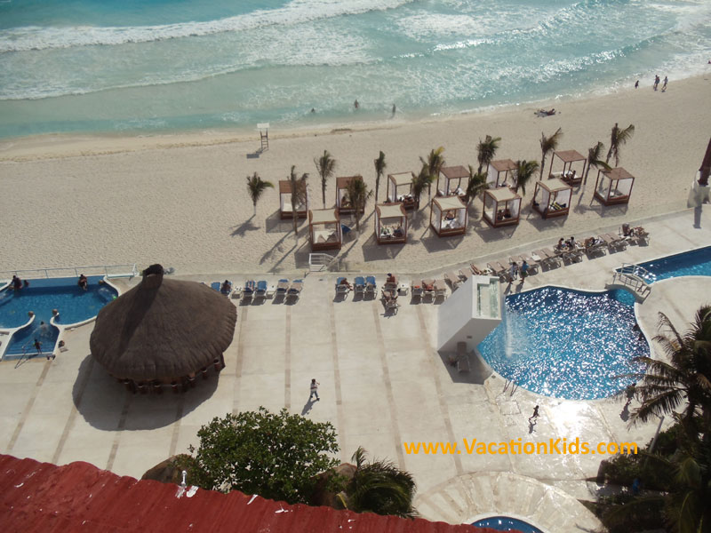 View of the beach and beach beds at Krystal Hotel Cancun