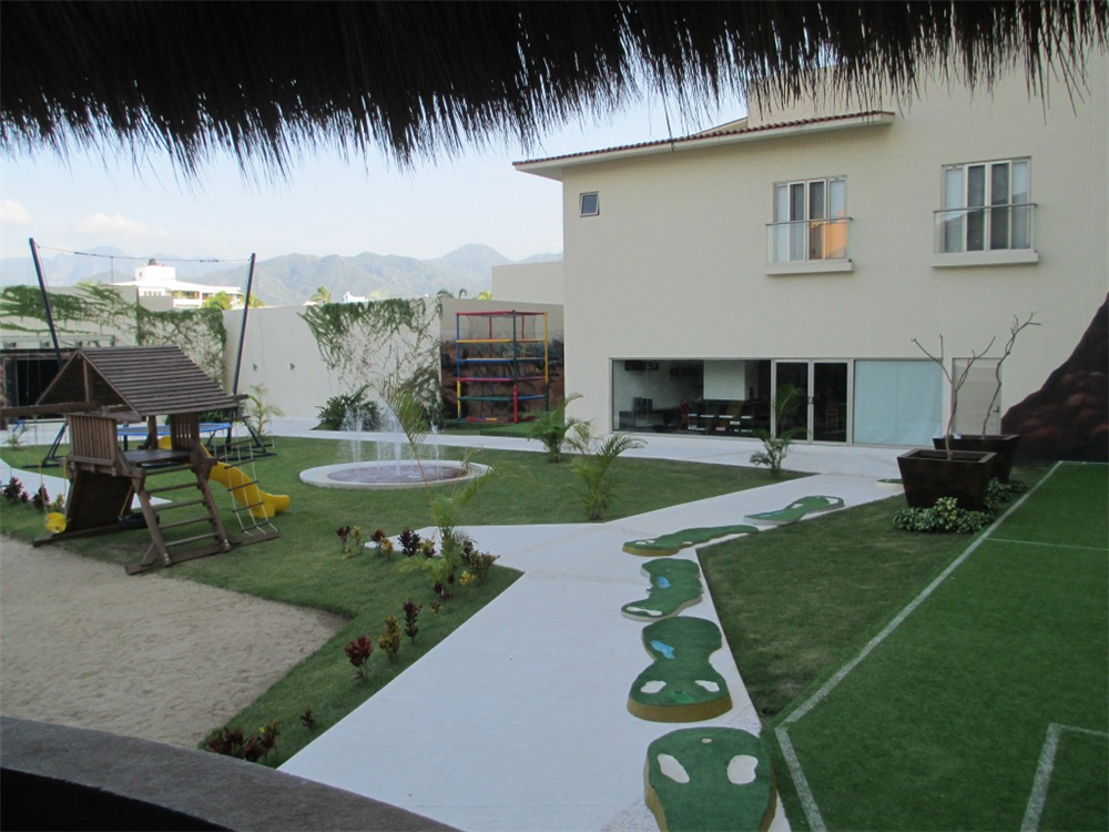 View of outdoor play area complete with play ground, trampoline and splash fountains at Now Amber Resort