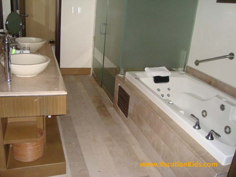 Full marble baths with separate showers and jetted tubs at Now Puerto Vallarta