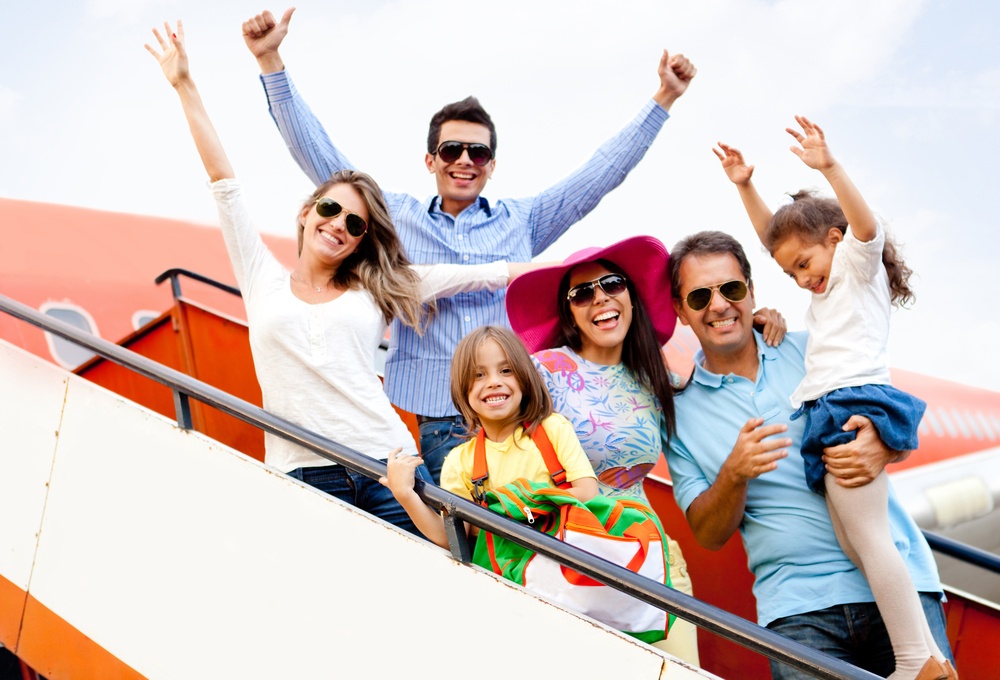 Excited family with arms up traveling by airplane-1
